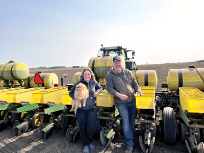 Two farmers standing infront of seeder